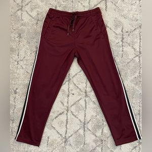 Women’s maroon sweatpants with black/white side details